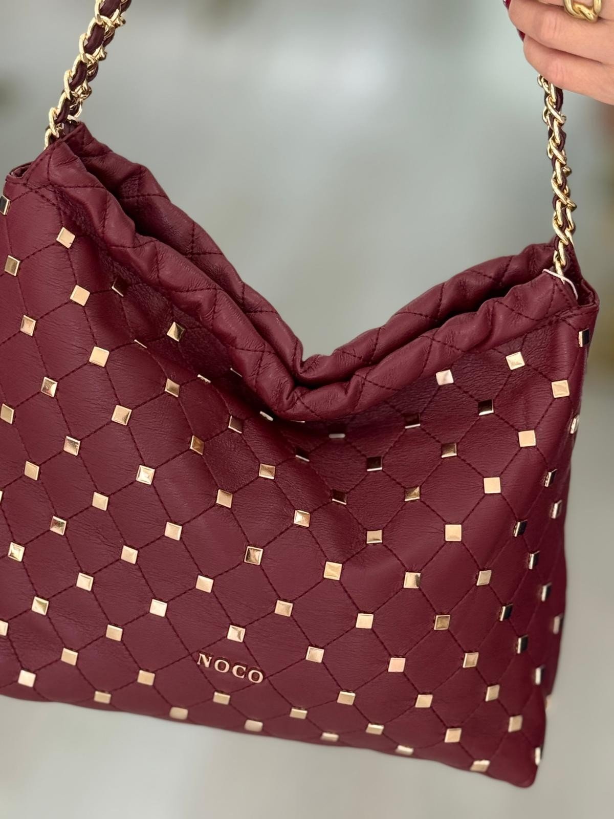 Mala tipo saco com tachas
