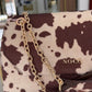 Bolsa a tiracolo com aba e estampado